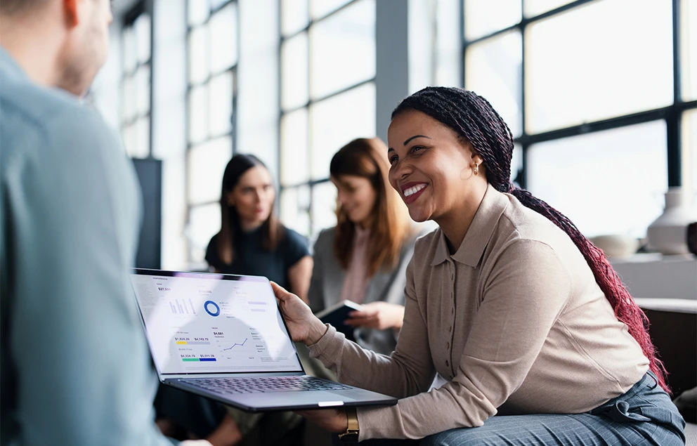 Woman holding laptop.